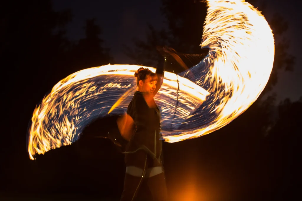 Spektakuläre Feuershow von Elements of Fire mit großen Flammen-Snakes bei Nacht.